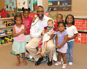 Charles E. Moore, MD with children after health education class. Dr. Moore is the 2011 Gold Foundation Award recipient for Humanism in Medicine. Photo courtesy of Jim and Tamie Lyles.