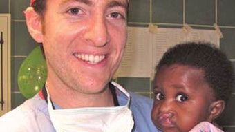 David A. Gudis, MD, with a young girl about to have surgery for her bilateral cleft lip.
