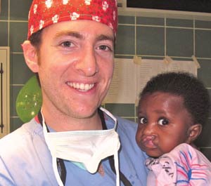 David A. Gudis, MD, with a young girl about to have surgery for her bilateral cleft lip.
