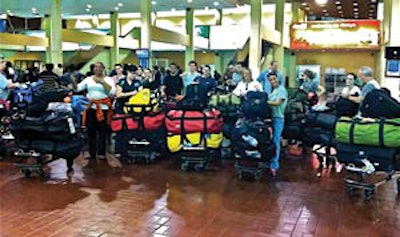 The entire team paused with 50 bags of medical equipment at the Kenya airport.