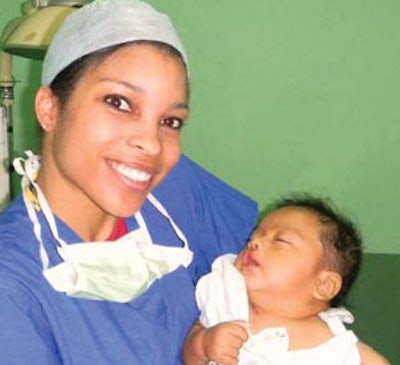 Melynda Barnes, MD, holding a baby after cleft lip repair.