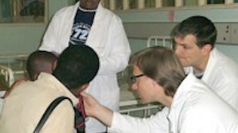 Drs. Tollefson and Ledgerwood examining a post-op patient at Harare Central Hospital, Harare, Zimbabwe.