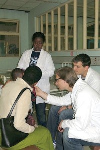 Drs. Tollefson and Ledgerwood examining a post-op patient at Harare Central Hospital, Harare, Zimbabwe.