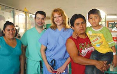 Residents Adam M. Terella, MD, and Jessyka K. Lighthall, MD, with a FACES patient and his family.