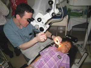 Dr. Eric Wilkinson examines a child’s ear in clinic.