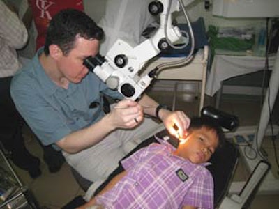 Dr. Eric Wilkinson examines a child’s ear in clinic.