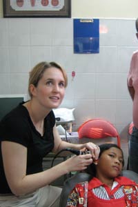 Dr. Ashley Balaker uses an otologic endoscope to evaluate ear disease in a Cambodian girl.