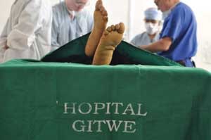 Members of the anesthesia team prepare a patient for surgery at Gitwe Hospital.