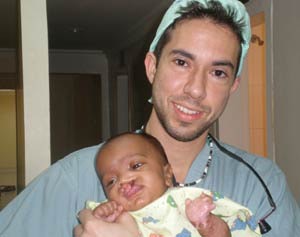 Team member Joseph Rousso, MD, with pre-op complex cleft-lip patient.
