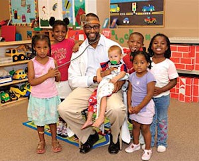 Dr. Charles Moore visits with children after health education class. Photo courtesy of Lyle Photography.