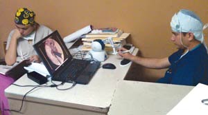 Otolaryngology resident and attending physicians study temporal bone surgery using the Ohio State temporal bone simulator at Escuela Hospital Antonio Lenin Fonseca, Managua, Nicaragua.