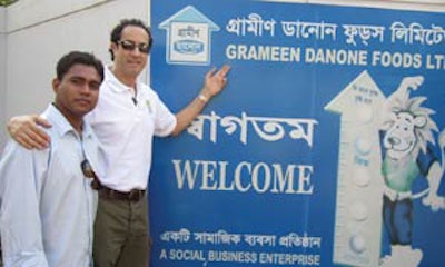 Dr. Seidman (right) visits Grameen Danone, where the CEO of Dannon Yogurt and Professor Yunus collectively serve the poor and malnourished with Shokti Doi, a yogurt fortified with iron, calcium, and other nutrients.