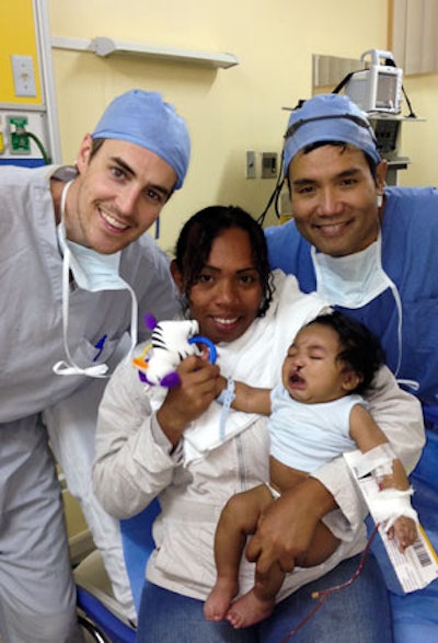 Drs. Adam and Howard Boey with a patient and mother after cleft lip surgery.