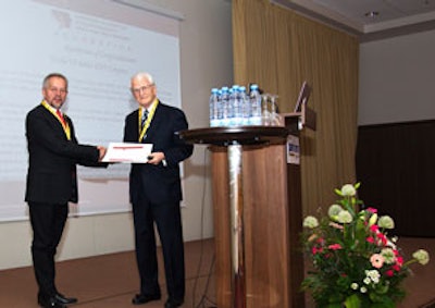 Eugene N. Myers, MD, presenting a proclamation from AAO-HNS to Prof. Virgilijus Ulozas, president of the sixth Baltic Congress.