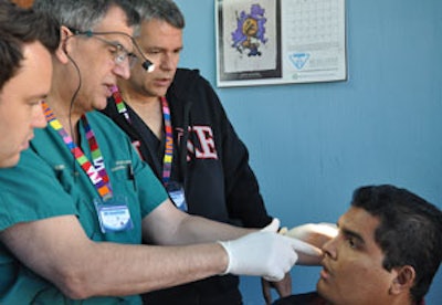 Team evaluation of a clinic patient during surgical screening. Left to right: Jeffrey Watson, MD, Russell Kridel, MD, J. Charlie Finn, MD.
