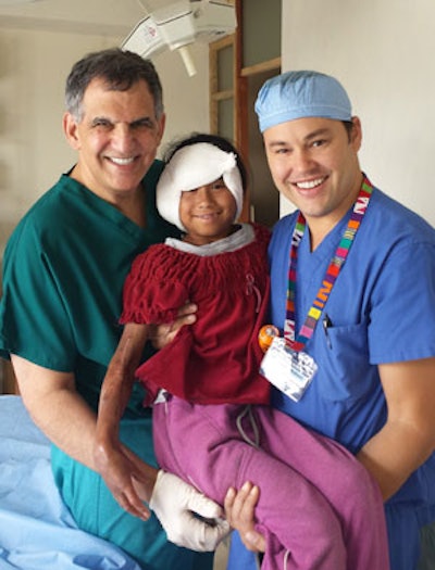 A young patient in good spirits after her auricular reconstruction and scar contracture release for deformities from severe burns. Left: Russell Kridel, MD; right: Jeffrey Watson, MD