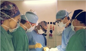 Team leader Dr. Dhingra takes residents through a thyroidectomy procedure.
