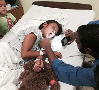 Dr. Siva Chinnadurai examining 11-year-old cleft patient Arely on postoperative day one following her pharyngeal flap.