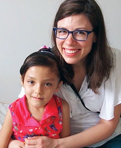 Myriam Loyo, MD, and patient Yosely share a hug the day after Yosely’s palate surgery.