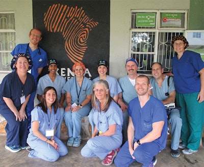 Katherine Nickley, MD, third seated on the bench, and Team 22 grin for the camera.