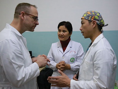 Dr. Liu, department chairman from Gansu Provisional Hospital, discussing management of patient’s with cleft lip and palate with the team members.