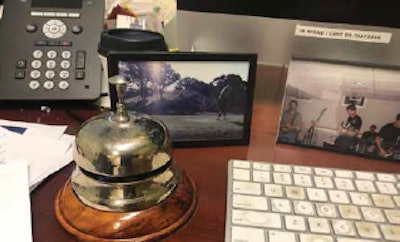 The commemorative concierge bell from the AAO-HNSF 2005 Annual Meeting panel I moderated still sits on my desk. Just behind this is a photo of the late Bob Toohill teeing off at Eagle Springs, WI, in 2002. It is one of my most cherished memories.