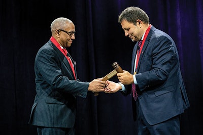 The ceremonial passing of the gavel between Duane J. Taylor, MD, and Albert L. Merati, MD, during the Welcome Ceremony.