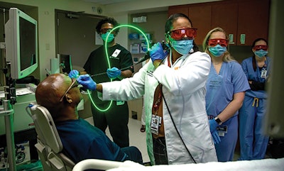 Figure 1: Photo of Dr. Gillespie’s faculty, Dr. Sandra Stinnett, using office-based laser to treat vocal cord dysplasia.