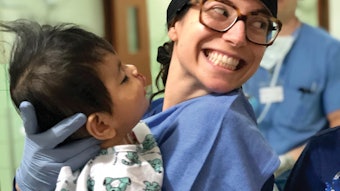 Natalie Krane, MD, transfers a patient who just underwent cleft lip repair to the post-anesthesia care unit.