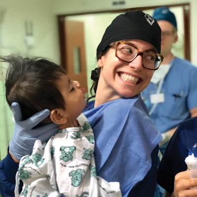 Natalie Krane, MD, transfers a patient who just underwent cleft lip repair to the post-anesthesia care unit.