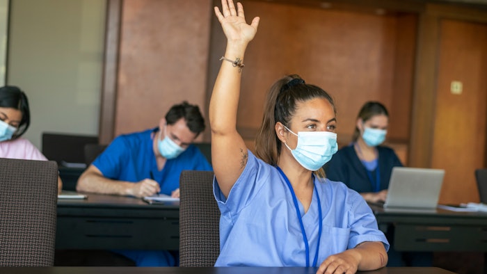 Medical students in masks in a classroom setting