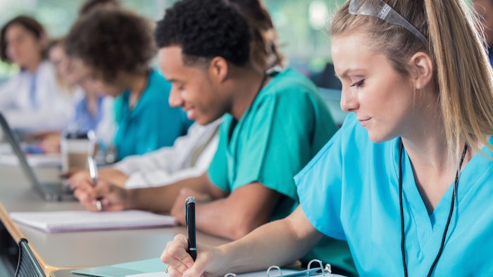 Medical students taking notes in class
