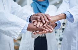 Image of doctors clasping hands together