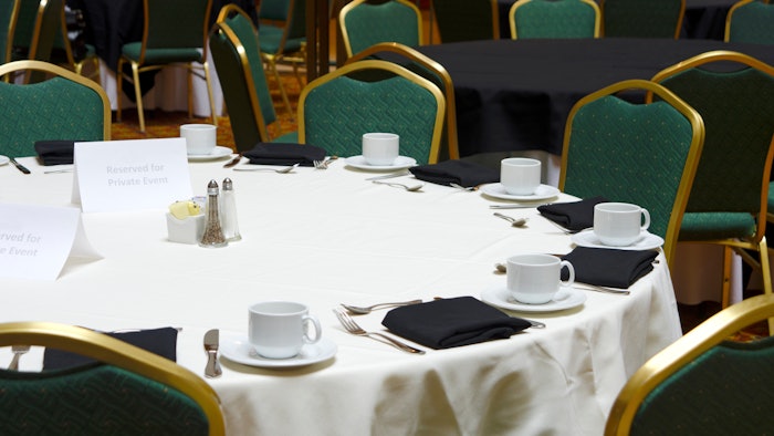 Meeting hall table set for breakfast