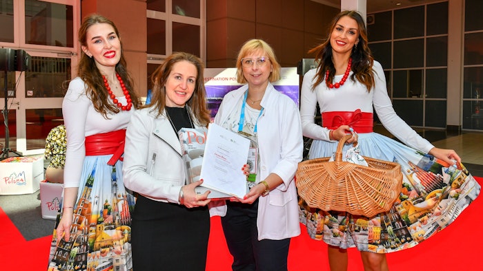 Aneta Ksiazek, head of Poland Convention Bureau, presents Carina Bauer, CEO, IMEX Group, with a gift and certificate to mark 20 years of IMEX, and 20 years since the birth of the Poland Convention Bureau.