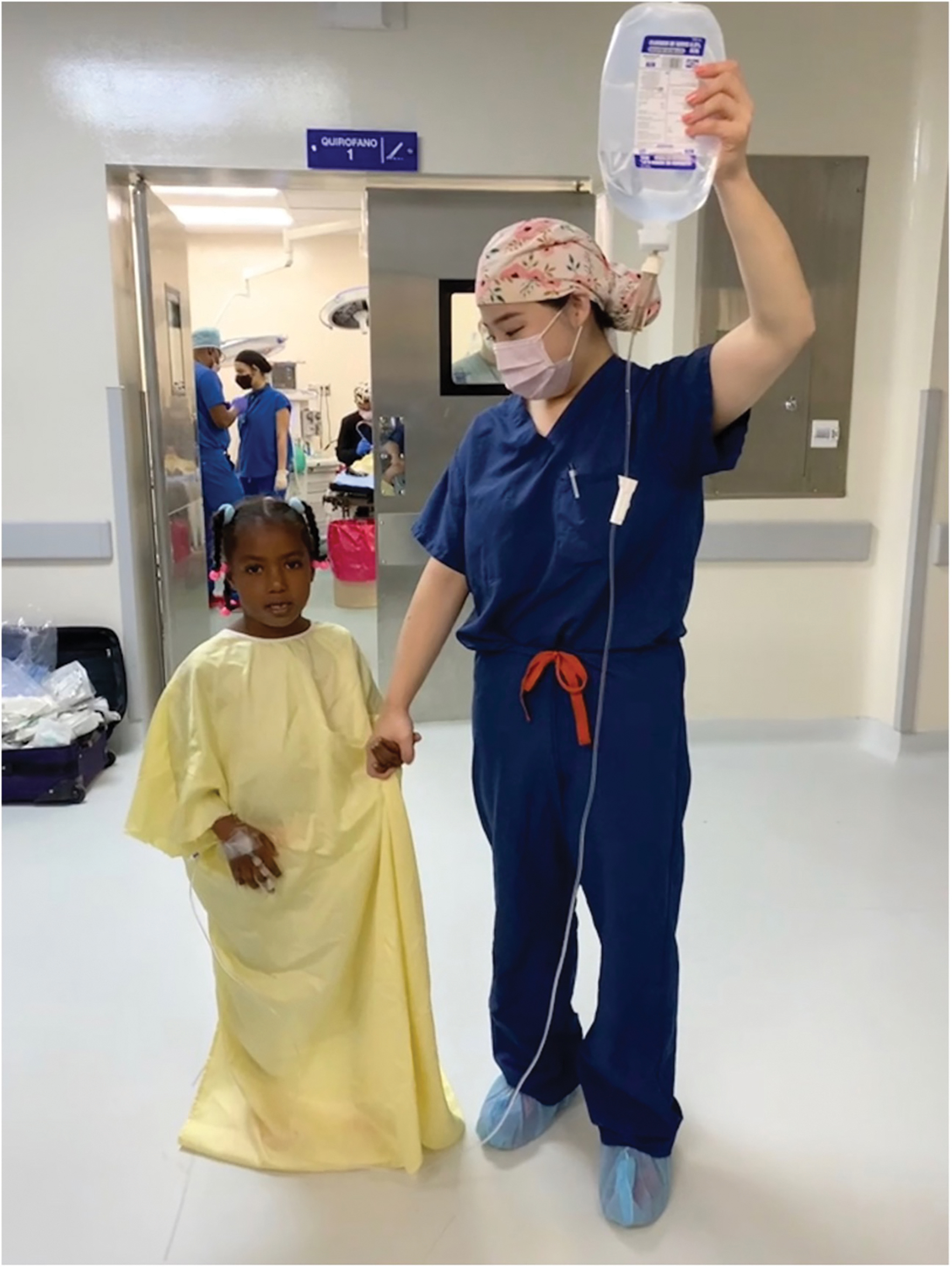 Dr. Sara Yang leading a patient into the operating room