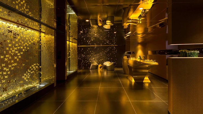 In the entry foyer at W Bogota Hotel, golden butterflies fly along an accent wall, and this theme continues in the guest rooms with metallic hues, gold accents and colorful mosaic tiles.