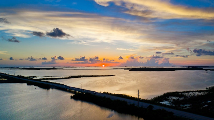 The setting sun is reflected off the Gulf of Mexico just south of Sugarloaf Key, Florida, in the Lower Florida Keys.