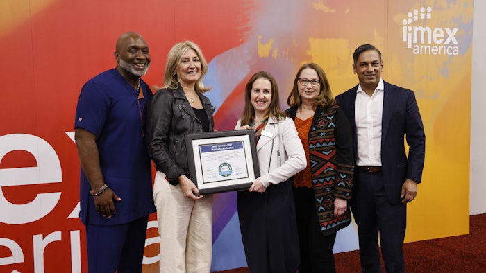 Carina Bauer (center), IMEX Group CEO, accepts the Platinum Level certification for Sustainable Event Standards from the Events Industry Council.