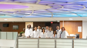Group of pharmacists in white jackets