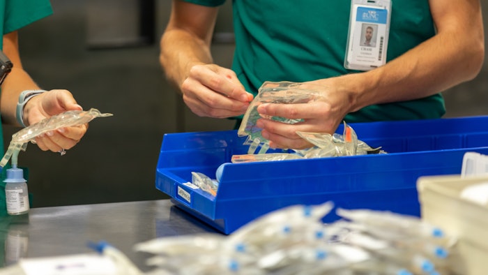 Photo of pharmacy technicians sorting pharmacy equipment