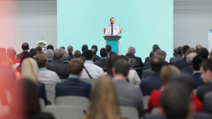 Doctor giving lecture in front of a convention crowd