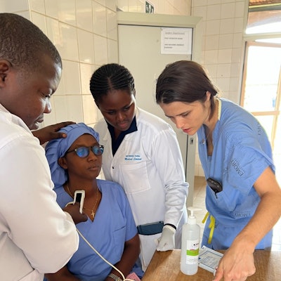 Dr. Lilly reviewing thyroid anatomy via point of care ultrasound with Rwandan medical students.