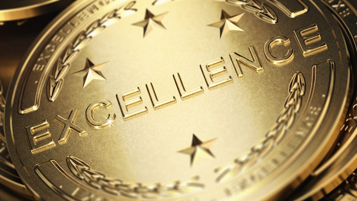 Gold medal with the word excellence engraved on it