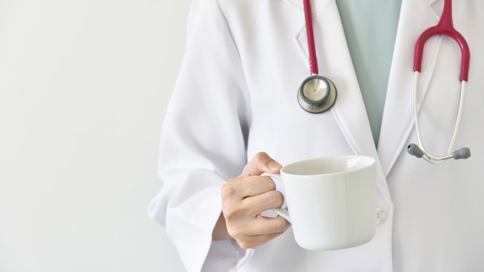 doctor holding a cup of coffee