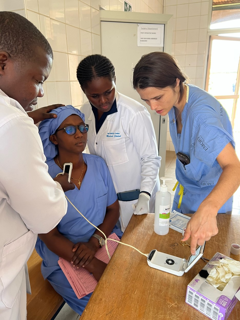 Dr. Lilly reviewing thyroid anatomy via point of care ultrasound with Rwandan medical students.