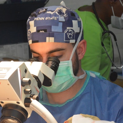 Dr. Bowers working under the operating microscope to repair a stenotic ear canal secondary to an accidental auricular avulsion.