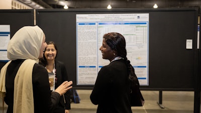Attendees talk with Scientific Poster authors regarding their research during the 2022 Annual Meeting.