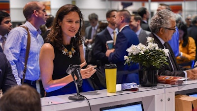 Attendee is welcomed at Registration.