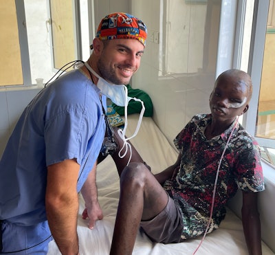 Brentley Lindsey, MD, with a patient at Tawfiq Hospital.